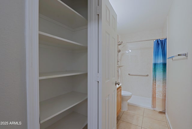 bathroom featuring tile patterned floors, toilet, and a shower with shower curtain