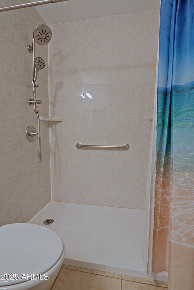 bathroom featuring curtained shower and toilet