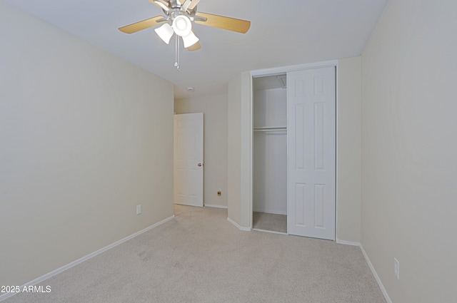 unfurnished bedroom featuring light carpet, a closet, and ceiling fan