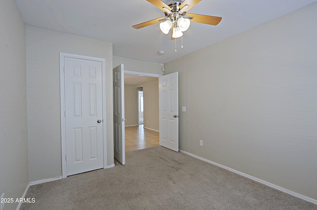unfurnished bedroom with ceiling fan and light carpet