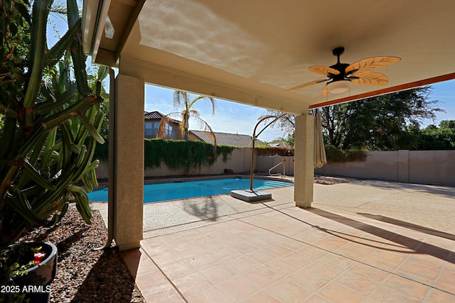 view of swimming pool featuring a patio area and ceiling fan