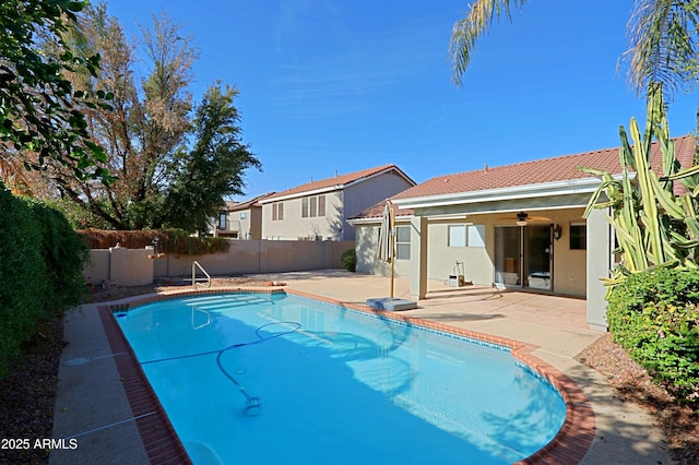 view of swimming pool featuring ceiling fan and a patio