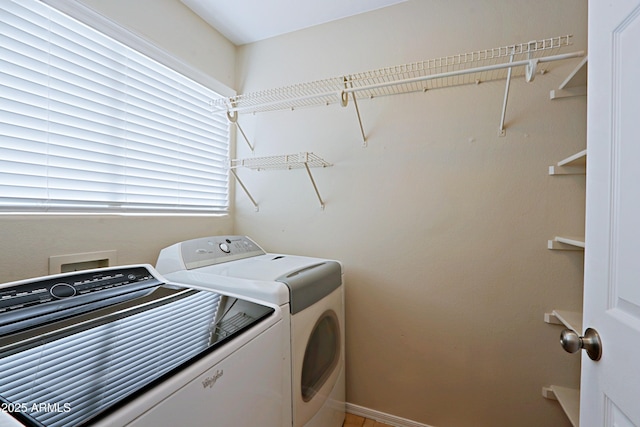 clothes washing area featuring washing machine and clothes dryer