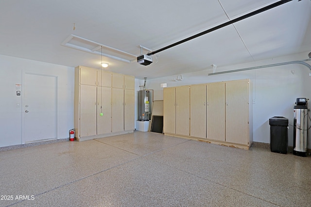 garage with gas water heater and a garage door opener