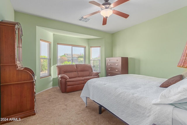 bedroom featuring ceiling fan and light carpet