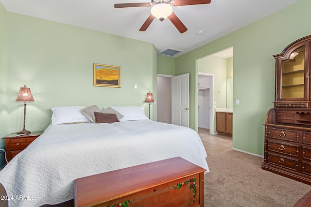 carpeted bedroom featuring ceiling fan and ensuite bath