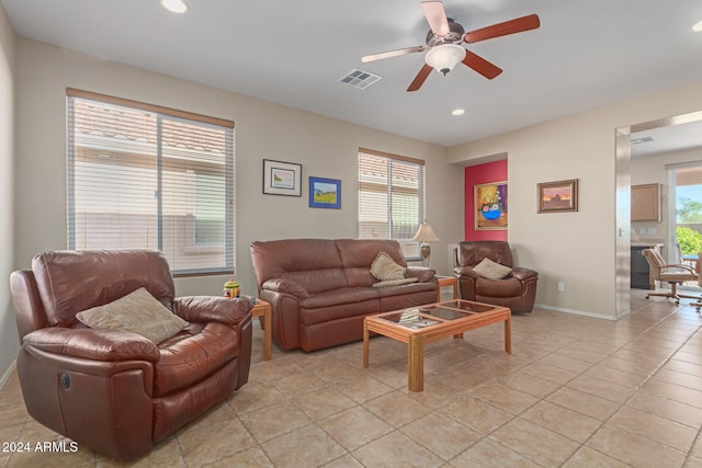 tiled living room with ceiling fan and a wealth of natural light