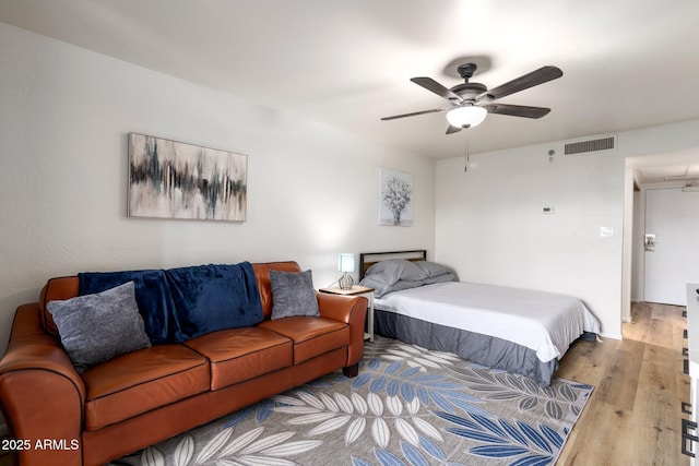 bedroom with ceiling fan and light hardwood / wood-style flooring