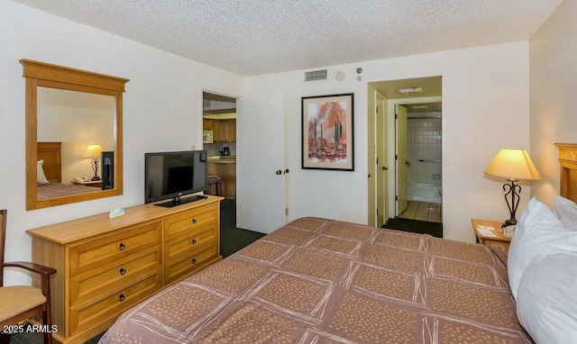 bedroom featuring connected bathroom and a textured ceiling