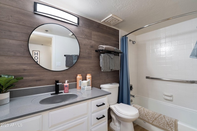 full bathroom featuring wood walls, vanity, toilet, shower / bathtub combination with curtain, and a textured ceiling