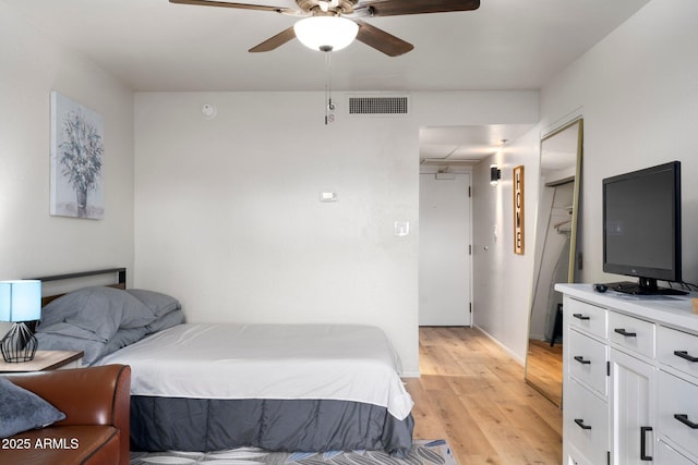 bedroom featuring light hardwood / wood-style floors and ceiling fan