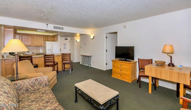 living room with dark carpet and a textured ceiling