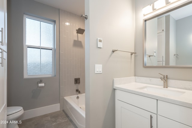 full bathroom with tiled shower / bath combo, vanity, and toilet