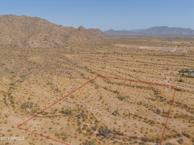 aerial view featuring a desert view and a mountain view