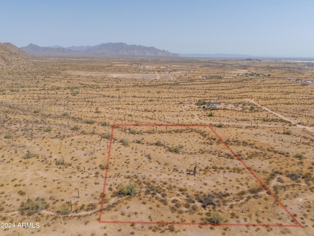 birds eye view of property featuring view of desert, a rural view, and a mountain view