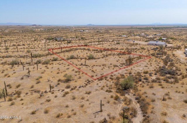 drone / aerial view featuring a mountain view, a rural view, and view of desert