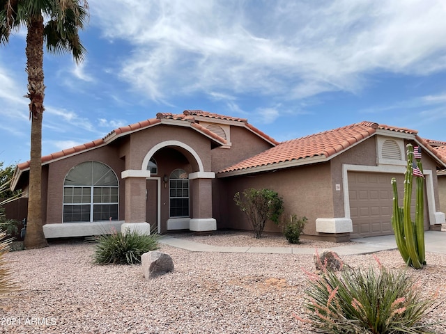 mediterranean / spanish-style home featuring a garage