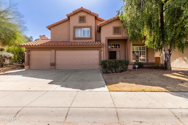 mediterranean / spanish-style house with stucco siding, a chimney, driveway, and a tiled roof