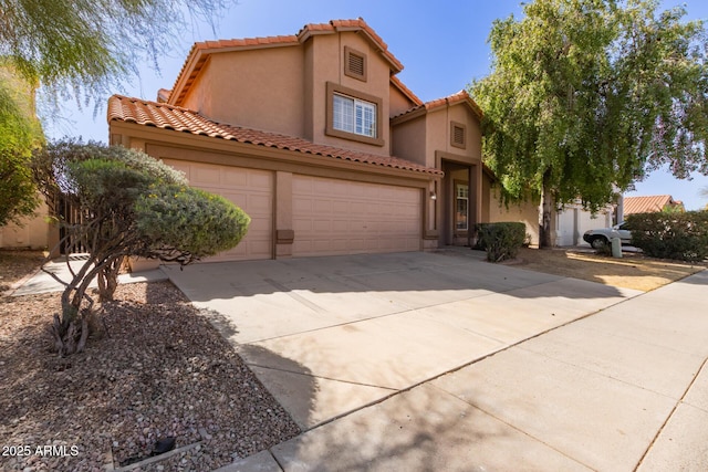 mediterranean / spanish home with stucco siding, a garage, and concrete driveway