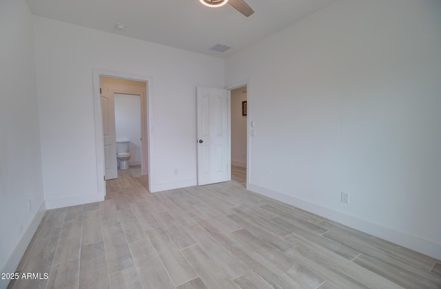 1519 N Etta St, Casa Grande, AZ 85122 - unfurnished bedroom featuring light wood-type flooring, connected bathroom, baseboards, and a ceiling fan