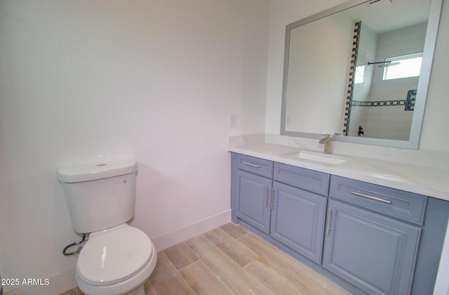1519 N Etta St, Casa Grande, AZ 85122 - bathroom with toilet, vanity, baseboards, wood tiled floors, and tiled shower