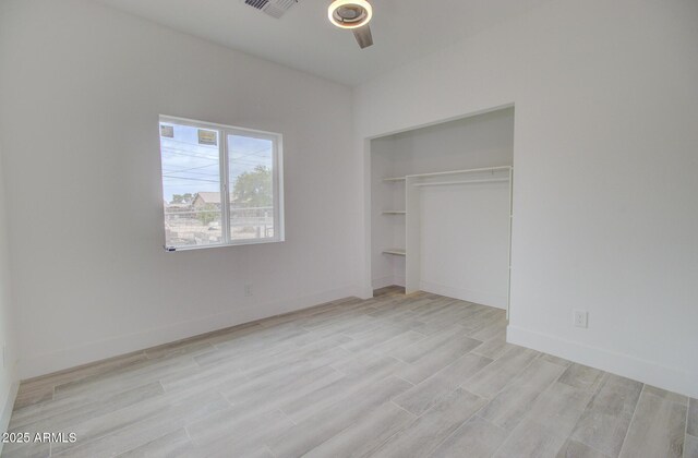 1519 N Etta St, Casa Grande, AZ 85122 - unfurnished bedroom with light wood-type flooring, a closet, a ceiling fan, and baseboards