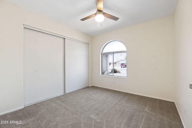 unfurnished bedroom featuring a closet, carpet, and ceiling fan