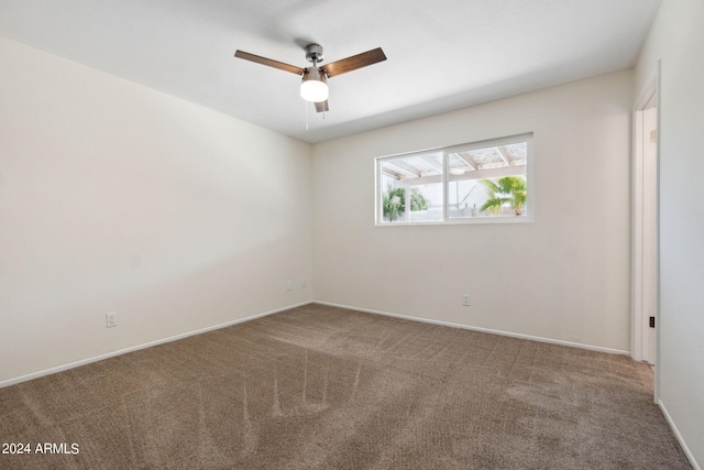 spare room with carpet floors and ceiling fan