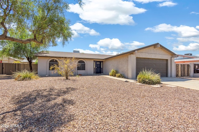 ranch-style home featuring a garage