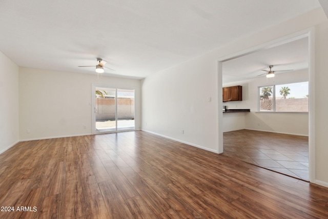 empty room with ceiling fan and hardwood / wood-style flooring