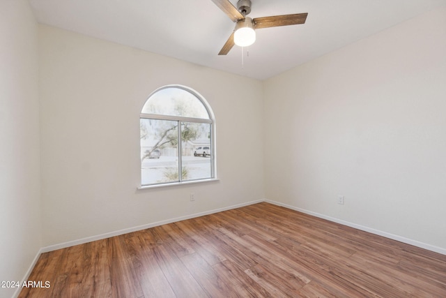 unfurnished room with ceiling fan and hardwood / wood-style flooring