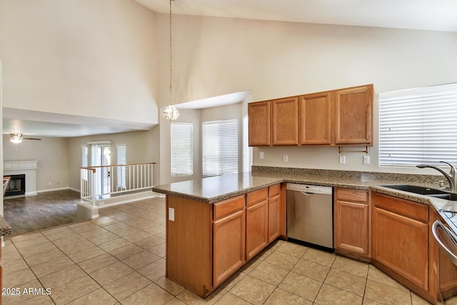 kitchen with light tile patterned floors, a peninsula, a sink, stove, and dishwasher