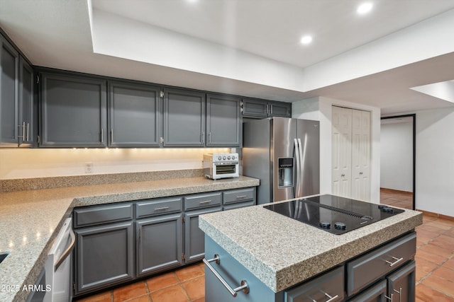 kitchen with light tile patterned floors, light countertops, stainless steel refrigerator with ice dispenser, and black electric stovetop
