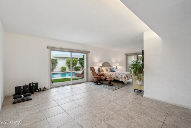 bedroom with light tile patterned floors and access to exterior