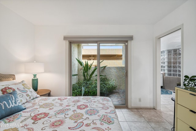 bedroom with access to outside and light tile patterned flooring