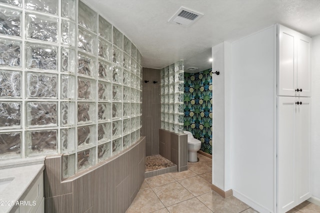 bathroom with toilet, a walk in shower, tile patterned flooring, and visible vents