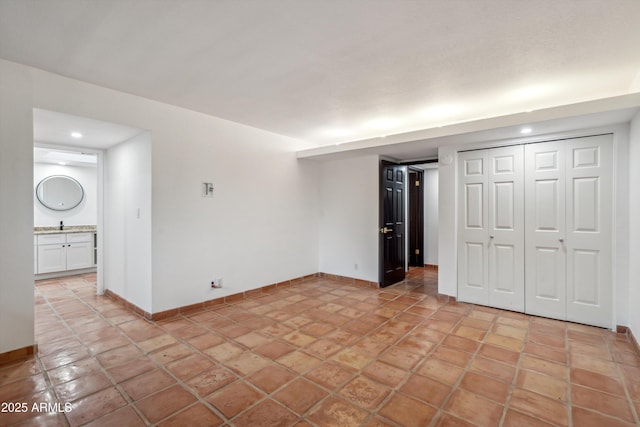 unfurnished bedroom with a closet, baseboards, and recessed lighting