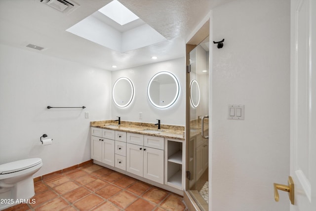 bathroom with a sink, visible vents, a skylight, and double vanity