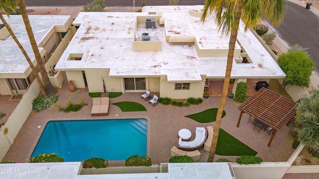 outdoor pool with a patio area and a fenced backyard