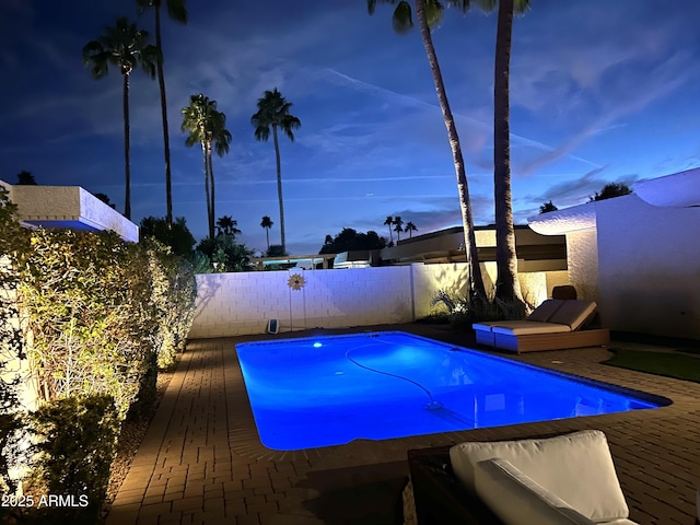 view of pool with a fenced in pool and fence