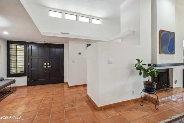 entrance foyer featuring visible vents, baseboards, and a healthy amount of sunlight