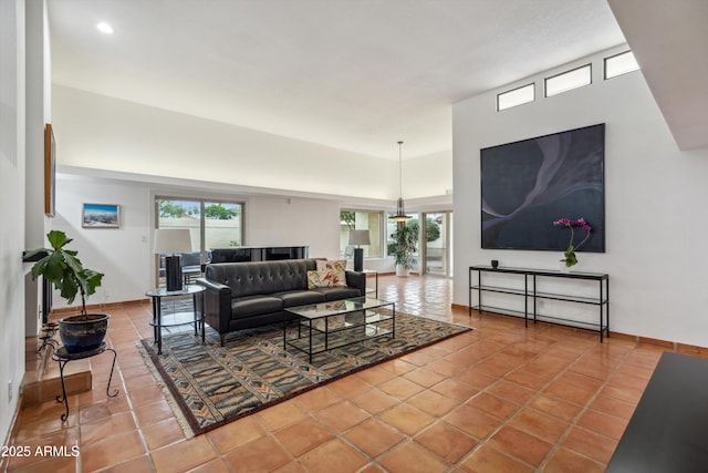 living room featuring tile patterned floors and a high ceiling
