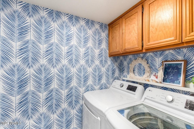 laundry area with cabinets and washer and clothes dryer