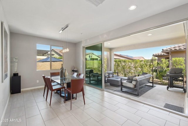 dining space with recessed lighting, baseboards, a notable chandelier, and tile patterned floors