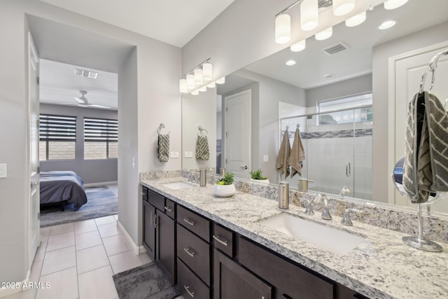 ensuite bathroom with a sink, visible vents, and tile patterned flooring