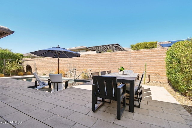 view of patio featuring outdoor dining space and a fenced backyard