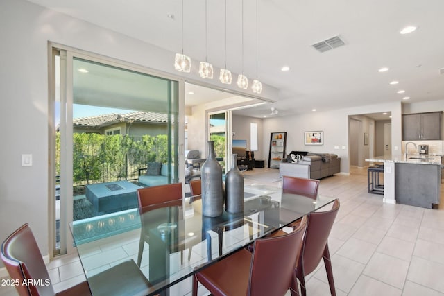 dining space with light tile patterned floors, visible vents, and recessed lighting