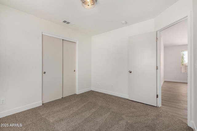 1727 W 12th Ave, Apache Junction, AZ 85120 - unfurnished bedroom with a closet and carpet flooring