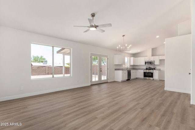 1727 W 12th Ave, Apache Junction, AZ 85120 - unfurnished living room with a chandelier, vaulted ceiling, ceiling fan, light wood-type flooring, and recessed lighting