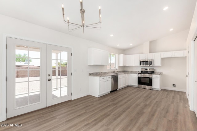 1727 W 12th Ave, Apache Junction, AZ 85120 - kitchen with appliances with stainless steel finishes, a chandelier, french doors, white cabinets, and light wood-type flooring